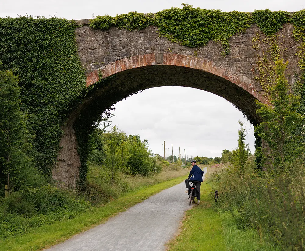 A man standing with cycle on Self Directed tour